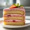 A slice of Strawberry Birthday Cake on a small dessert plate