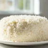 The Most Amazing Coconut Cake on a dessert plate