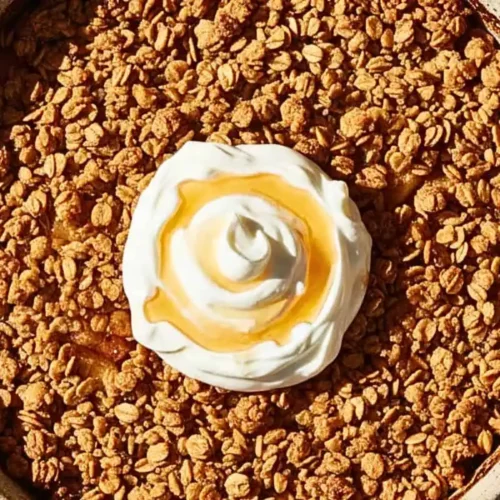 A Healthy Baked Apple Crisp in a rustic ceramic baking dish