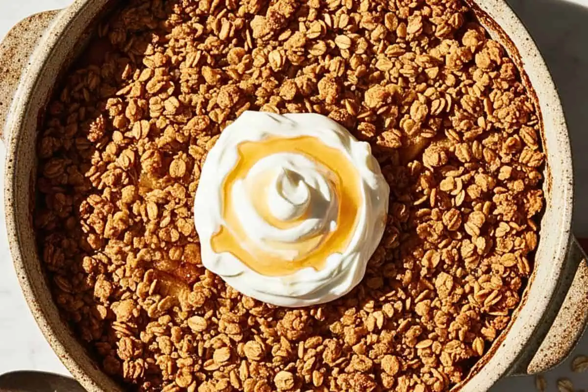 A Healthy Baked Apple Crisp in a rustic ceramic baking dish