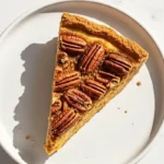 Single Slice of Sweet Potato Pecan Pie on a white ceramic plate