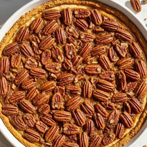 Sweet Potato Pecan Pie on a white ceramic pie dish