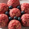 Berry Bliss Protein Balls in a white ceramic plate