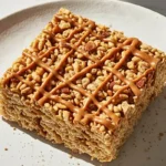 A Sigle slice of Caramel Apple Rice Crispy Treats dessert in a ceramic plate