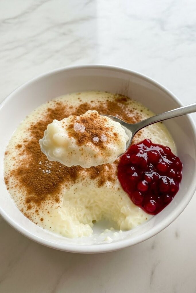 Swedish rice pudding with butter and cinnamon in a white bowl, a creamy and comforting classic European winter dessert